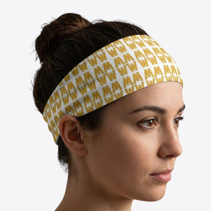 Maro Wilde white and gold repeating "W" pattern elastic headband made of polyester and elastane.